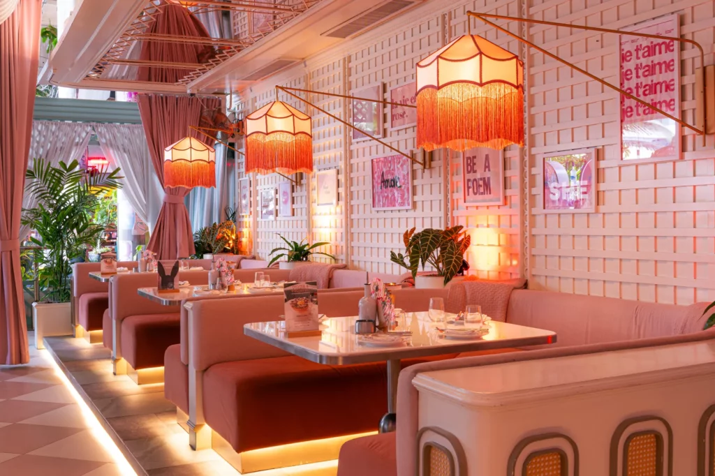 Front facing view of Mami Rose restaurant interior with striped ceiling and full seating layout.