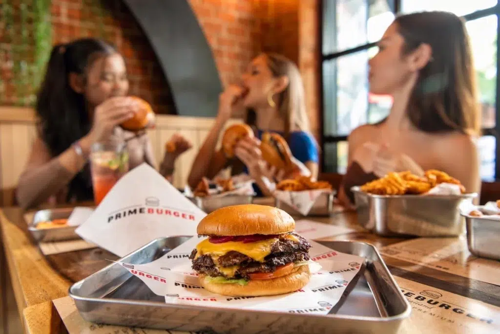 girls eating smash burgers and fries at Prime Burger in Bangkok Thailand